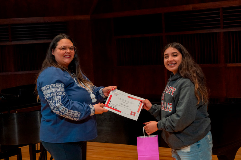 student receiving a certificate from faculty
