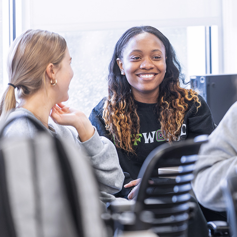 two students are smiling