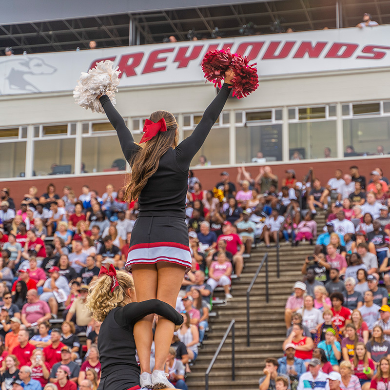 a cheerleader cheering at the crowd