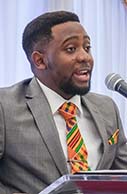 Craig Chigadza speaking at a podium