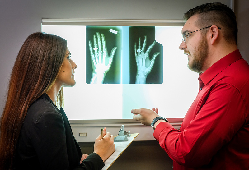 students looking at hand xrays