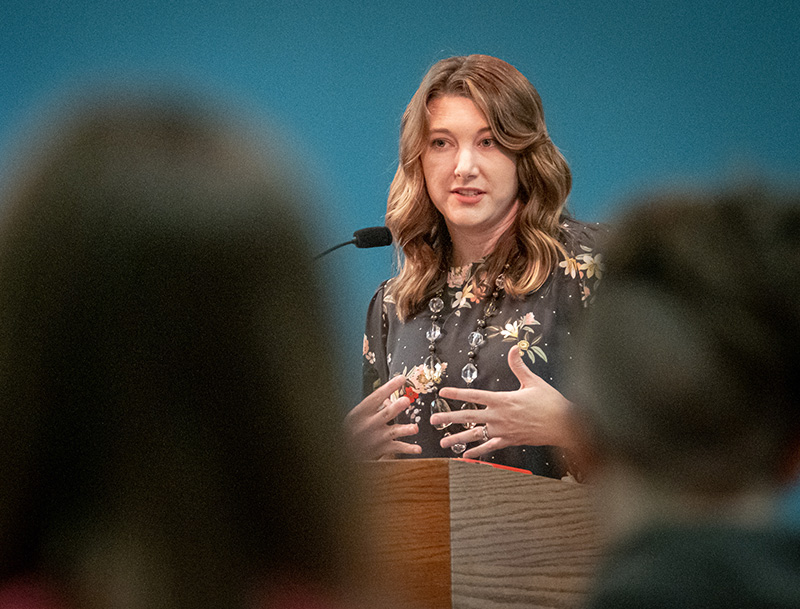 woman talking at a podium