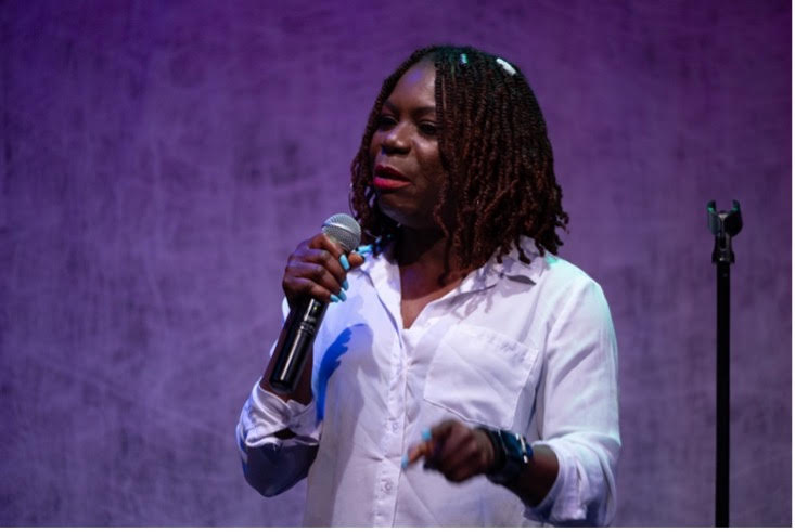 student on a microphone, presenting her showcase