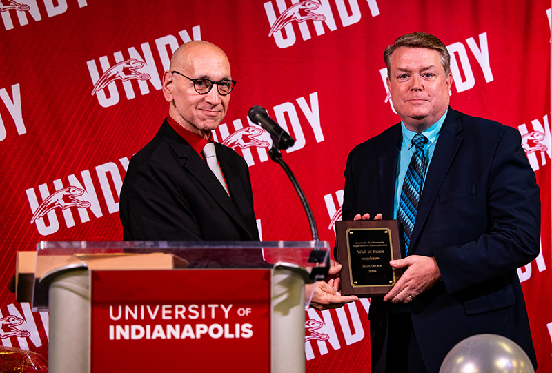 man presenting another man with an award