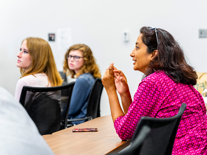professor sitting in the class with students