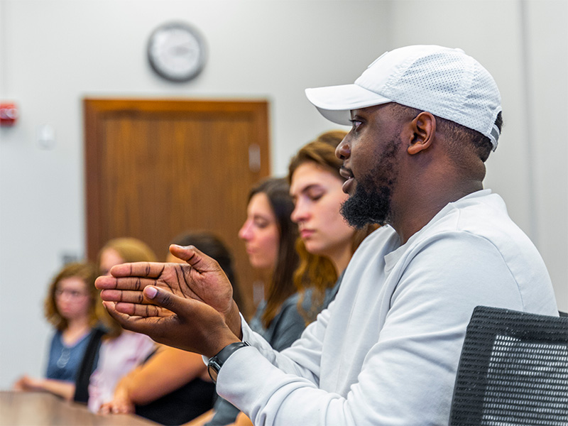 student speaking in the classroom