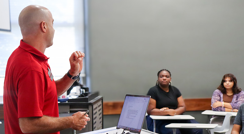 professor teaching in class in front of students