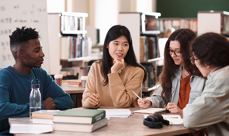 students having a discussion in the library