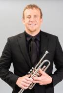 photo of daniel lewis holding trumpet