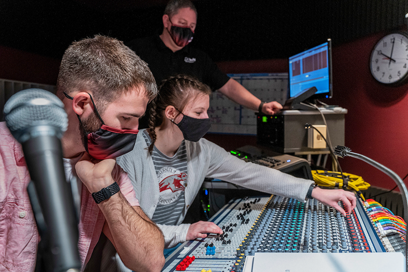 Students using music technology equipment in the studio