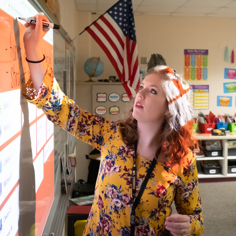 woman writing on a whiteboard
