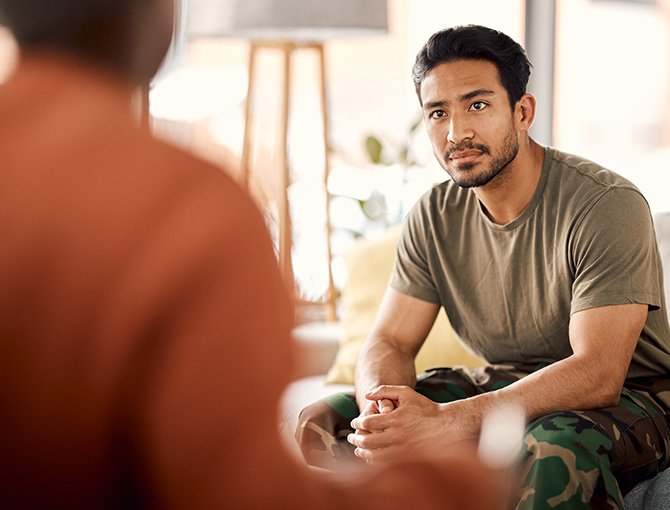 social worker talking to patient in military outfit