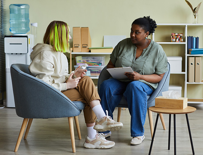 social worker at school talking with a student