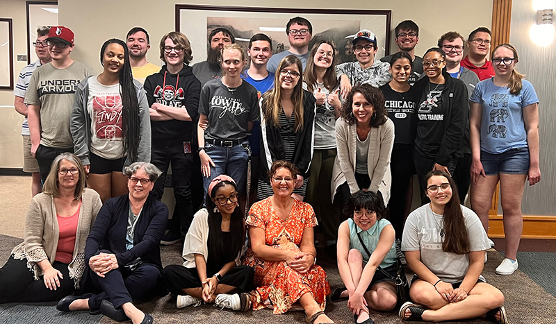 large group of happy students with staff