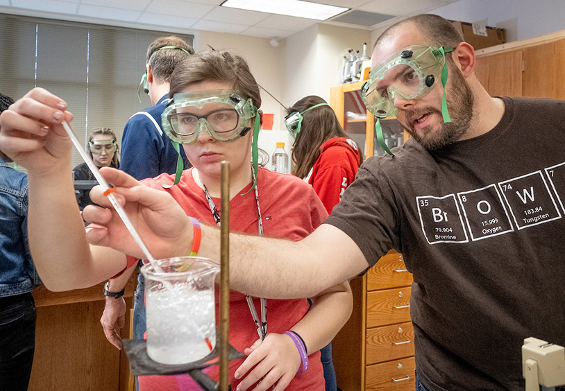 teacher teaching students in science lab