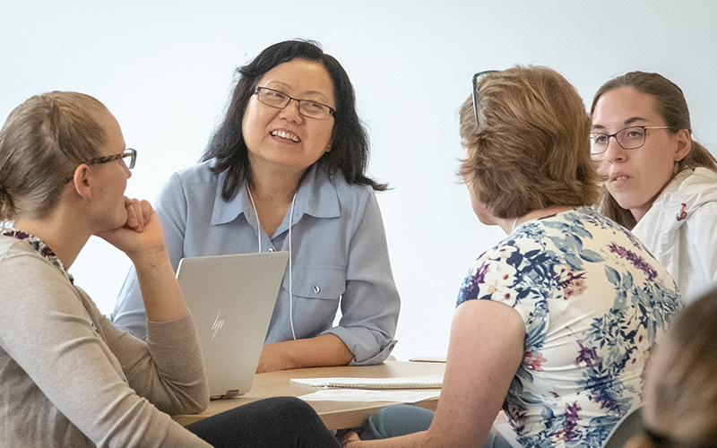 health professionals casually converse in a group setting