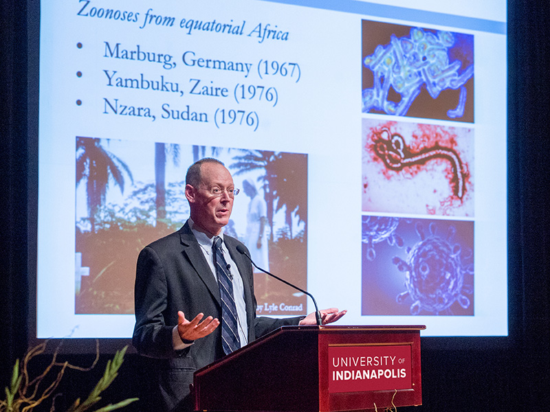a lecturer is standing at a podium during his presentation