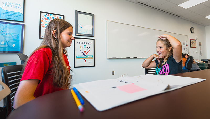 occupational therapy student working with a child