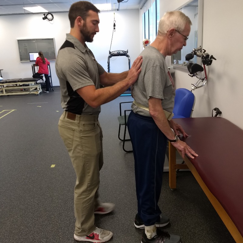 Male physical therapist with patient