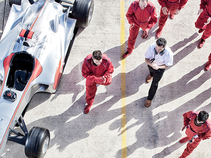 overhead view of a race car and the racing team
