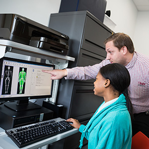 student and teacher in a lab