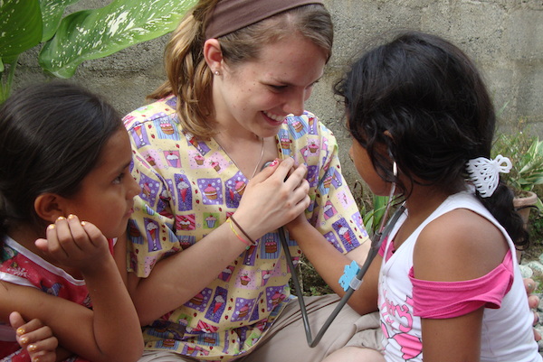 UIndy's nursing programs combine scholarship with service and offer a variety of service opportunities. Nurse with children.