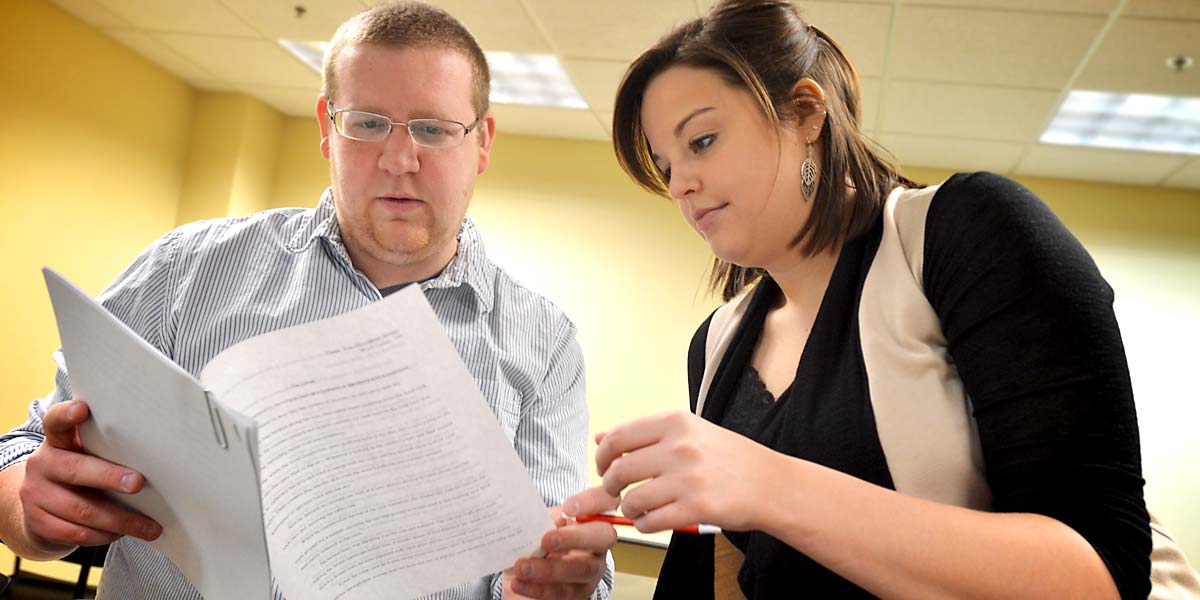 two student looks at papers