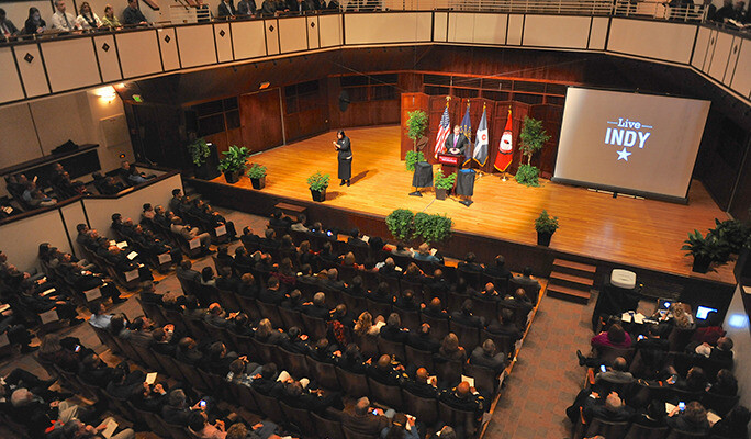 large audience is listening to a person on stage