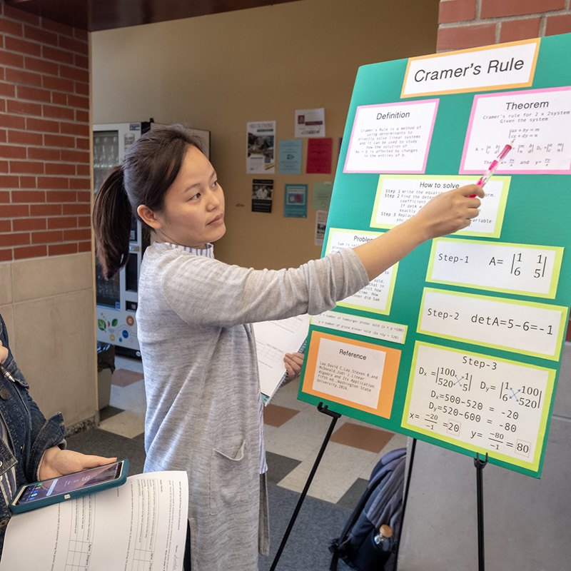 student with a math poster presentation
